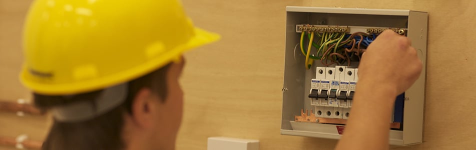 Engineering student working on a fuse box